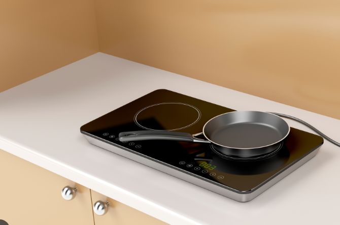 A frying pan on the portable cooktop